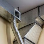 Air ducts and ventilation system showcasing metallic finishes and insulation for improved indoor air quality by HVAC experts.
