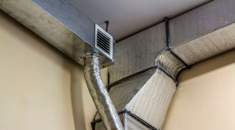 Air duct system with metal ducting and ventilation grille, part of Easco Air Conditioning’s HVAC solutions.