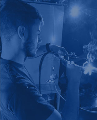 Young man using welding tools in a dynamic crafting environment at Easco Air Conditioning and Heating service.